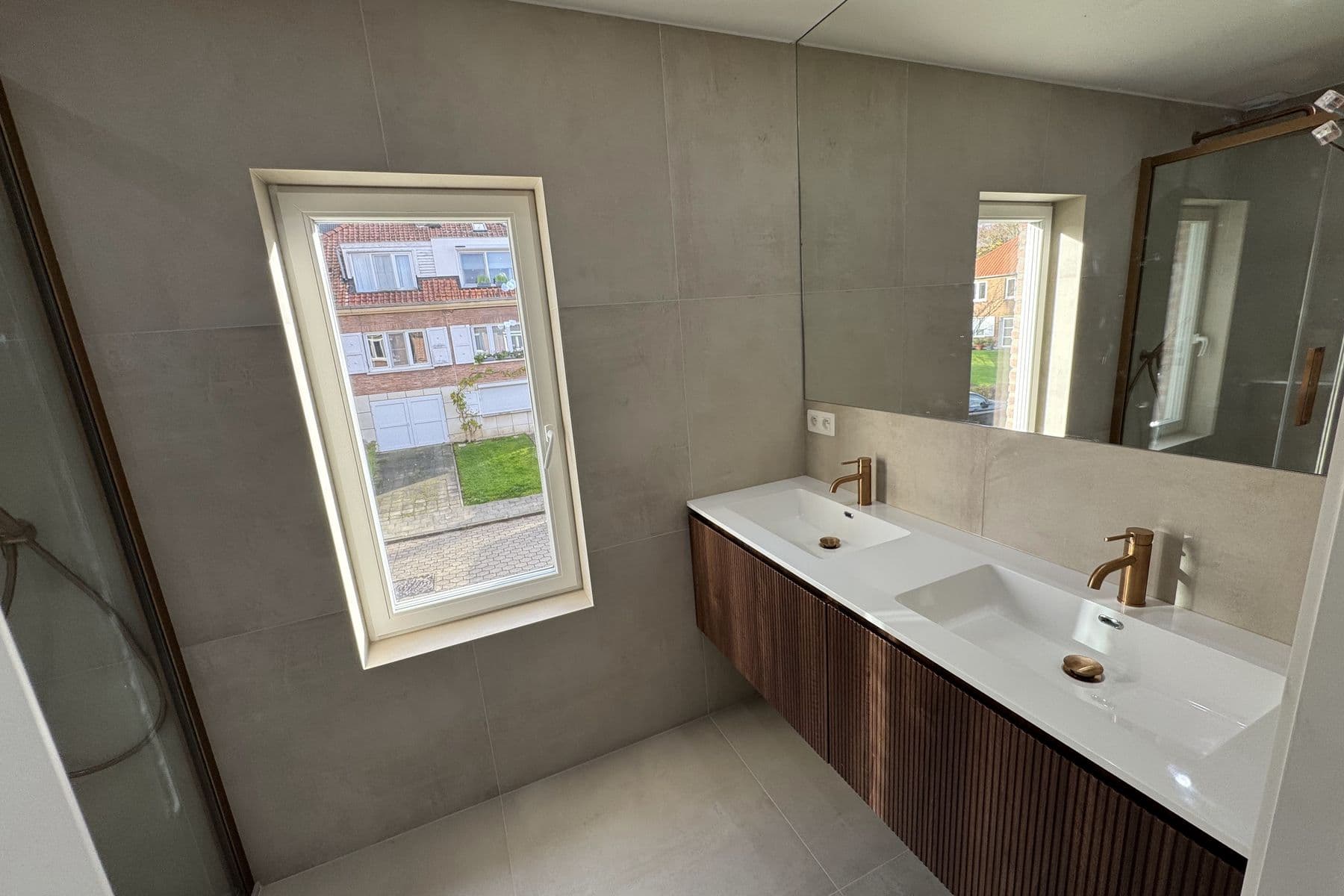 Double vasque cuivrée sous la fenêtre, grands carreaux gris et miroir sur toute la largeur